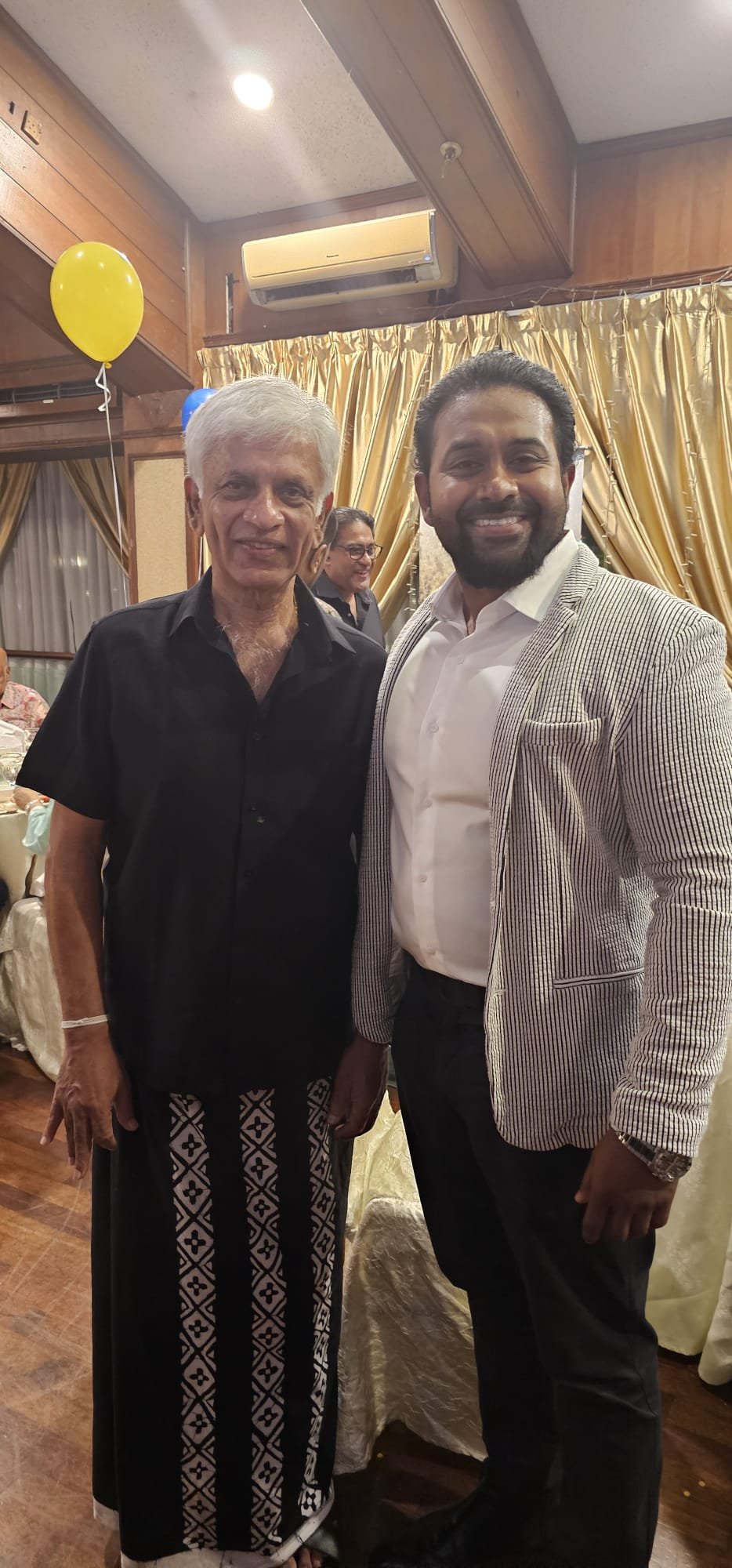 Gihan Ekanayake with a community member at an event